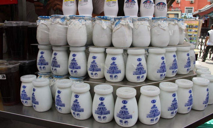 7. Sữa chua Bắc Kinh. Sữa chua Bắc Kinh là một trong những đặc sản được bày bán khắp các con phố. Với bí quyết gia truyền và được đựng trong những hũ sành, món quà vặt có hương vị tuyệt vời này sẽ để lại trong lòng bạn ấn tượng khó quên. Ngoài sữa chua lạnh thông thường, vào mùa đông, sữa chua còn được hâm nóng để giúp du khách giảm bớt cái lạnh.