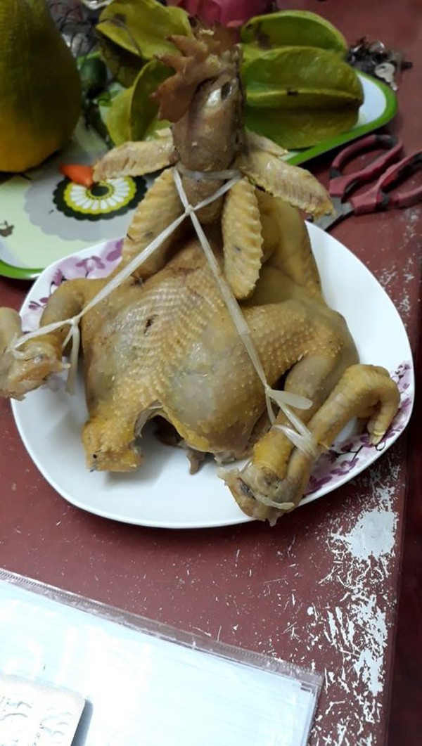 Rút kinh nghiệm từ người đi trước, một thành viên “hội đoảng” nghĩ ra cách chằng buộc kỹ càng để tạo dáng cho chú gà cúng.