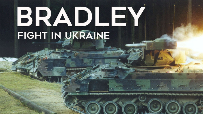 Trong bức ảnh là hai chiếc xe chiến đấu bộ binh M2A2 Bradley ODS-SA. Một chiếc được sơn màu xanh lá cây đậm đặc, trong khi chiếc còn lại được ngụy trang bằng các sắc thái khác nhau của màu xanh lá cây từ nhạt đến đậm.