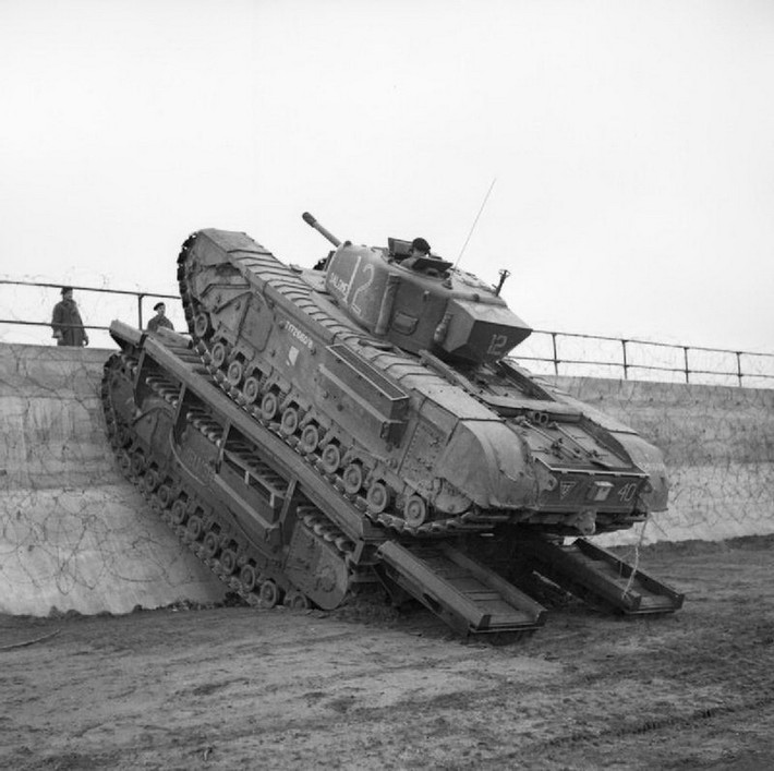 Trong ảnh là một chiếc Churchill Mk III với pháo chính 57mm tham gia vào chiến dịch đổ bộ của Đồng Minh lên bờ biển Normandy, đến cuối CTTG 2 trọng lượng của những chiếc Churchill ban đầu từ 39 tấn đã lên tới gần 41 tấn khi lớn giáp chúng phải mang theo ngày càng nhiều. Nguồn ảnh: IWM Prints.