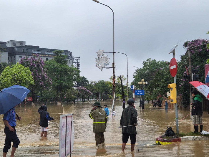 Người dân mang vó, cần câu ra phố bắt cá. (Ảnh: Dân Việt)