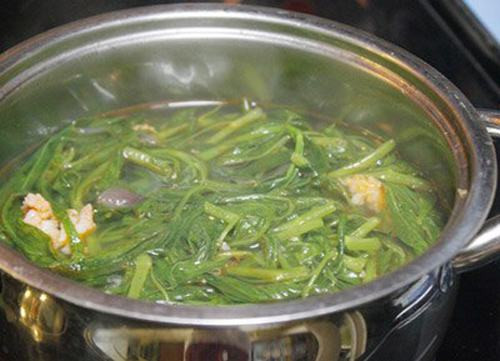 Khi sấu chín mềm, dầm dần sấu, nếm vị chua vừa đủ. Rau muống rửa sạch, dùng tay nắm rau muống thành nắm rồi vặn thành từng đoạn ngắn. Cho vào nồi canh, đun sôi đến chín là được. Ảnh: vaobepnauan.com.