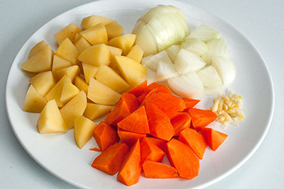 Khoai tây gọt vỏ, ngâm qua nước muối cho khỏi thâm rồi cắt miếng vừa ăn. Hành tây lột vỏ, cắt làm 4. Cho chân giò vào nồi áp suất cùng với khoai, hành, chút gia vị, lá quê, oregano, hầm nhừ. Nồi áp suất điện chỉ mất khoảng 30-40 phút, còn nồi thường khoảng một tiếng. Ảnh: cachlamsuonxaochuangotngon.blogspot.vn.