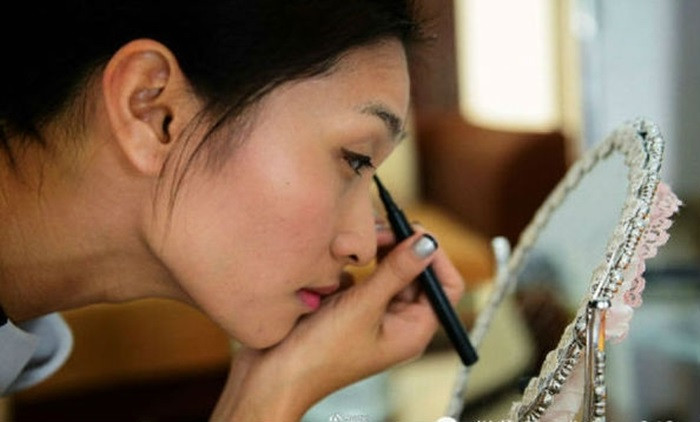 Trang điểm trước khi bắt đầu làm việc đó là công việc không thể quên của Azhu (Quảng Đông). Cô là hình ảnh cho những nữ nhân viên bất động sản.