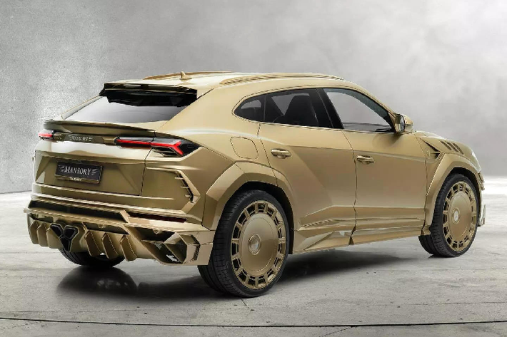 Với Venatus, chiếc Lamborghini Urus dát vàng từ hãng độ Mansory tiếp tục thu hút sự chú ý nhờ mặt trước và mặt sau mới mạnh mẽ, cũng như vô số thay đổi khác. Ở phía trước là thiết kế cản trước hầm hố với các hốc gió kích thước lớn, những đường nét và góc cạnh ấn tượng hơn so với Urus nguyên bản.