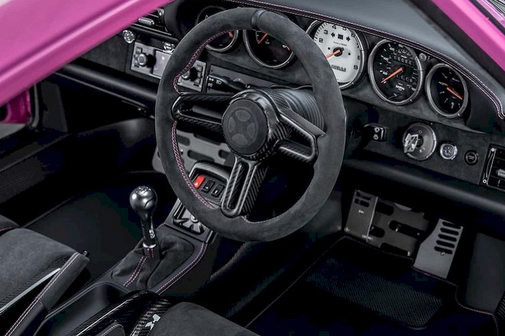 Ở bên trong nội thất, chiếc 911 993 Bubblegum này được trang bị ghế thể thao được làm bằng chất liệu sợi carbon bọc Alcantara và chỉ khâu màu hồng nổi bật. Taplo giữ nguyên cách bố trí nguyên bản với 5 đồng hồ dạng tròn, trong đó 4 đồng hồ mặt số màu đen và 1 đồng hồ ở giữa mặt số màu trắng.