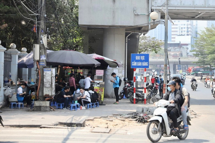 Theo ghi nhận của PV, tại khu vực nhà ga Cầu Giấy (phường Láng Thượng, quận Đống Đa, TP Hà Nội), bên cạnh lối lên nhà ga vẫn xuất hiện loạt quán ăn, quán trà đá lấn chiếm vỉa hè dành cho người đi bộ.