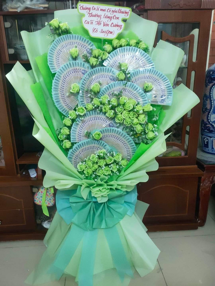 Bó hoa tiền fan tặng Hồ Văn Cường gồm những xấp tiền có mệnh giá 500.000 đồng được xếp thành hình quạt, kèm theo là dòng nhắn nhủ: “Chàng ca sĩ mà cô yêu thương. Thương tặng con ca sĩ Hồ Văn Cường. Cô Sài Gòn ".