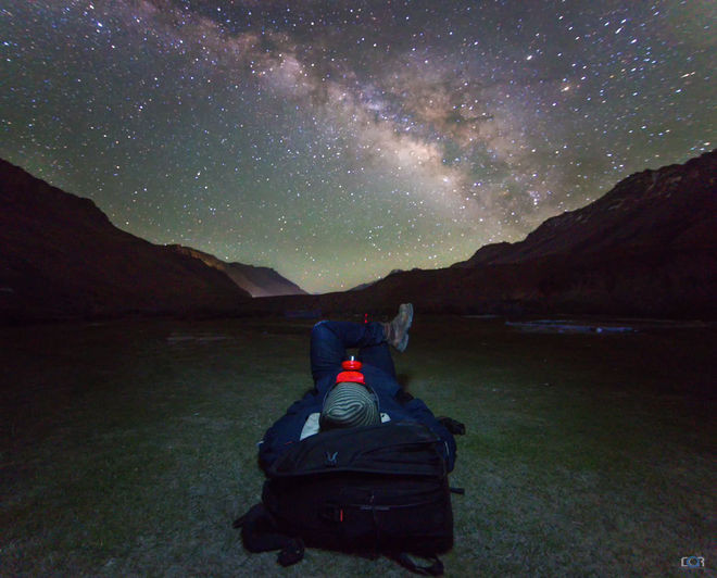 Một nhiếp ảnh gia thiên văn ngồi ngắm thiên hà Milky Way bắt chéo mình trên dãy núi hoang thuộc thị trấn Kaza ở Ấn Độ. Nguồn ảnh: Space.