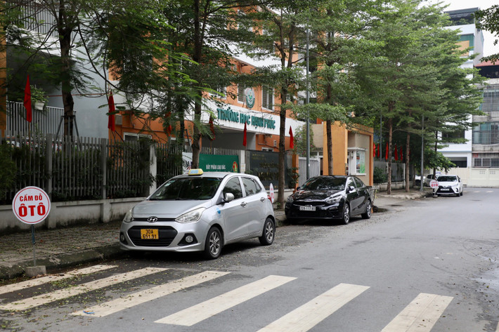 Nhiều ô tô bất chấp biển cấp vẫn đỗ tại khu vực cổng trường học nhưng không bị xử lý.
