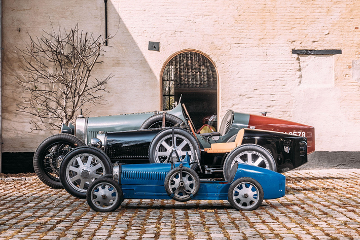 Ý tưởng này bắt nguồn từ năm 1926, khi Ettore Bugatti và con cả Jean Bugatti đã chế tạo một bản sao có kích thước bằng một nửa chiếc Type 35 nguyên bản để làm quà sinh nhật lần thứ 4 của cậu con trai thứ Roland Bugatti. Chiếc xe này có biệt danh là Bugatti Baby cho trẻ, được sản xuất với số lượng 500 chiếc từ năm 1927 đến năm 1936.