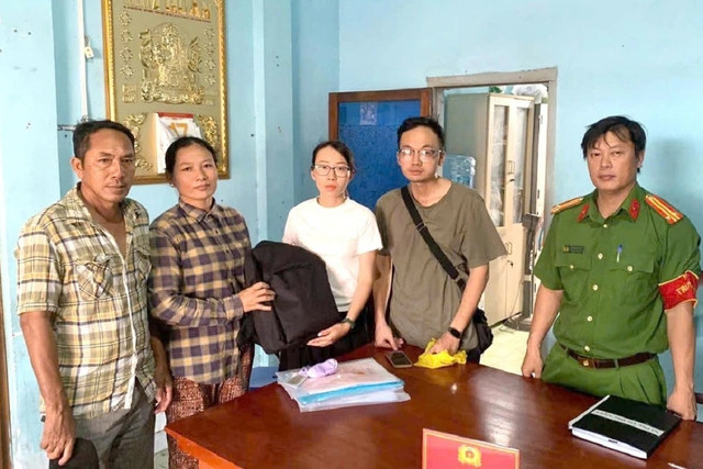 Chị Châu Thị Ngọc Lộc (áo caro đen) trao trả số vàng cho người bị mất - Ảnh: CALĐ. chi-loc-ao-ca-ro-den.jpg