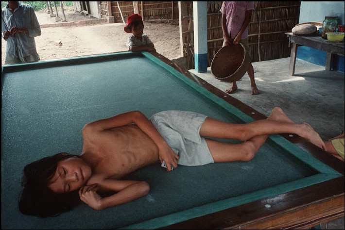 Cậu bé ngủ trên bàn billiard. Ảnh: Harry Gruyaert - Magnumphotos.com