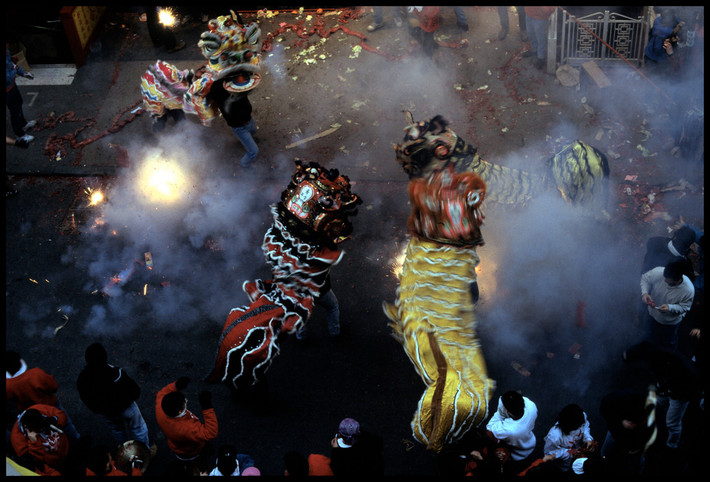Người Hoa múa lân và đốt pháo mừng năm mới ở Chinatown. Ảnh: Chien-Chi Chang/ Magnum Photos.