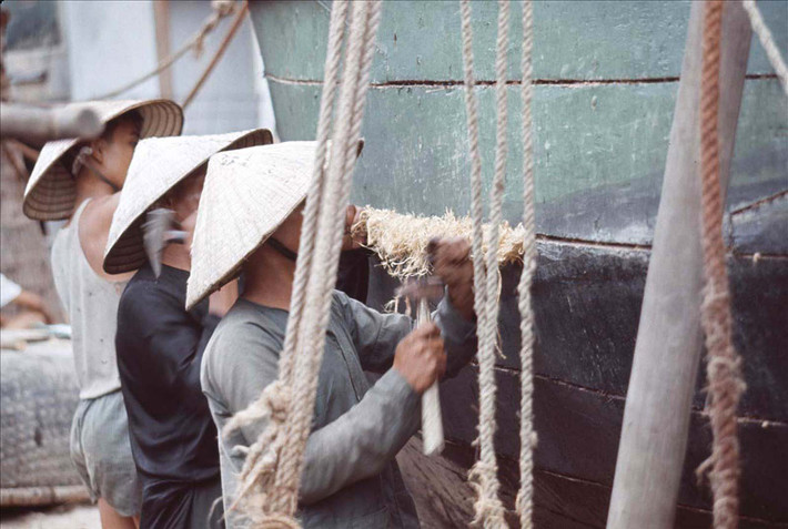 Trám những lỗ hổng trên thân thuyền bằng rơm và nhựa đường.