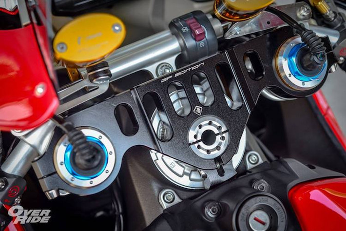Nằm ở khu vực tay lái của xe cũng là một loạt các "đồ chơi" hấp dẫn. Ngoài cây trợ lực Ohlins, chiếc xe còn có cặp bình dầu Rizoma Next và chảng 3 CNC GP Edition bằng nhôm siêu nhẹ của Ducabike. Bên dưới là nắp bình xăng đóng mở nhanh phong cách xe đua của Ducati Performance và 2 bên là cặp cùm phanh/côn Brembo GP.