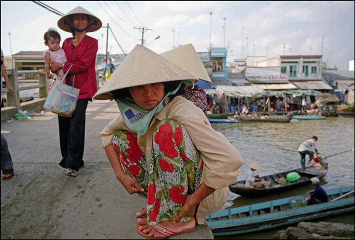 Trên một cây cầu bắc qua rạch Bảo Định ở thành phố Mỹ Tho, Tiền Giang. Ảnh: Ian Berry/ Magnum Photos.