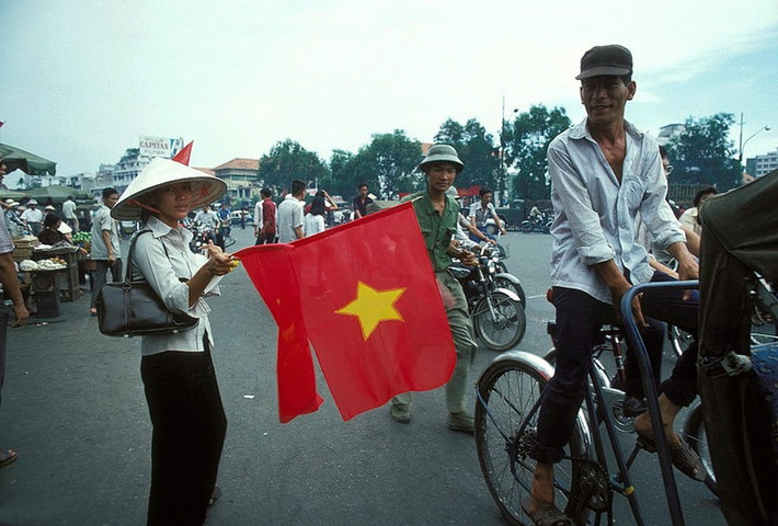 Người phụ nữ và lá cờ đỏ sao vàng.