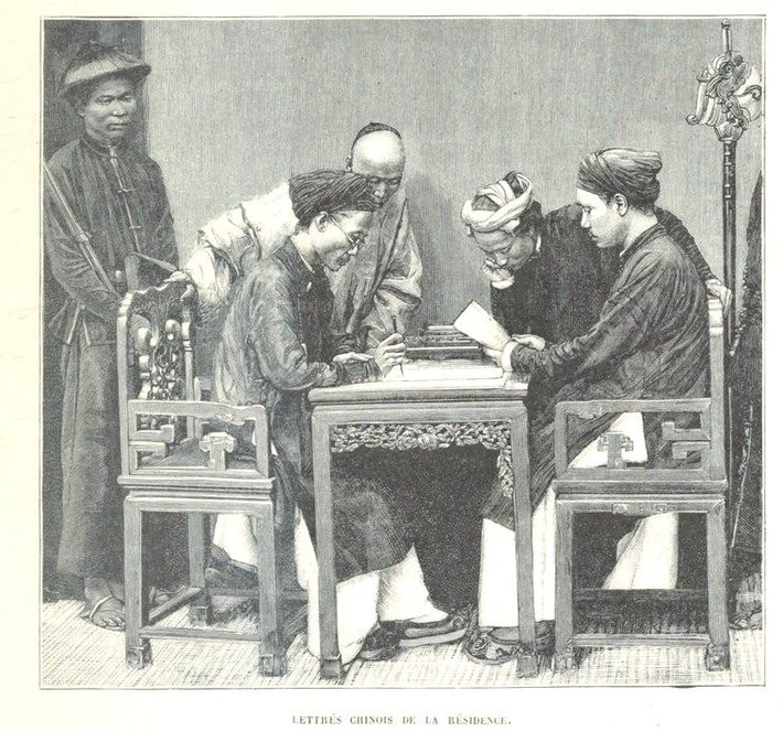 Các nhà nho ngồi bàn giấy với các gia nhân ở xung quanh.
