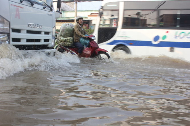 Dọc đường Huỳnh Tấn Phát cửa hàng buôn bán vẫn đóng cửa do nước ngập tràn vào nhà. Một số người dân dùng các tấm nilông che kín cửa ra vào để chắn nước. Nhiều con hẻm trên đường Huỳnh Tấn Phát cũng ngập tới đầu gối.