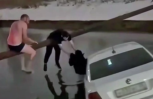 Người dân cứu một phụ nữ và một đứa trẻ khỏi chiếc taxi bị rơi xuống nước