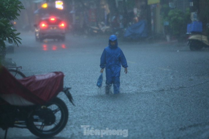Chỉ sau khoảng 15 phút nhiều phố phường nhanh chóng ngập trong biển lớn trong trời mưa lớn. (Ảnh Tiền Phong)