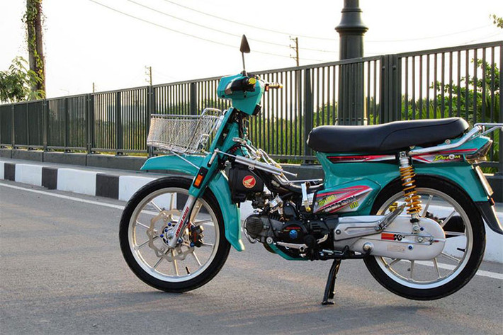 Chiếc Honda Dream đời cũ được sản xuất tại Thái Lan trong bài viết này của một người chơi xe Sài Gòn, tuy nhiên chiếc xe đã được người chơi làm mới lại dàn vỏ với màu xanh đầy cá tính, nổi bật ngoài đèn chiếu sáng halogen còn được độ đèn báo và xi nhan dạng led. Phía trước xe được trang bị thêm giỏ chở hàng phong cách.