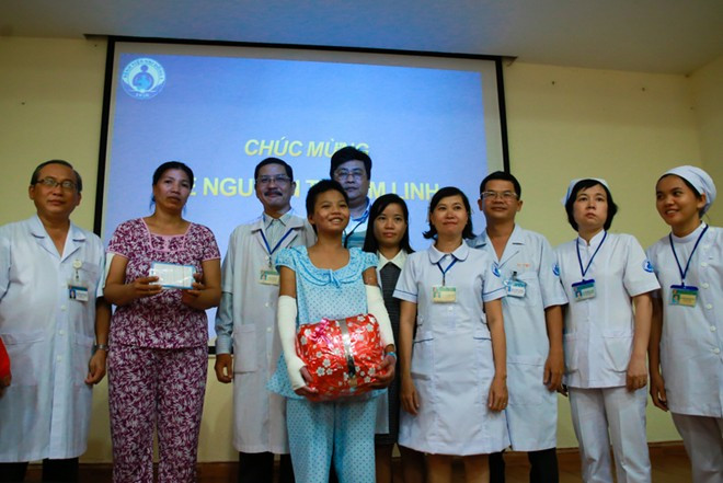 Linh tươi cười khi được nhận quà của các y, bác sĩ và hơn 800 triệu đồng của các nhà hảo tâm.