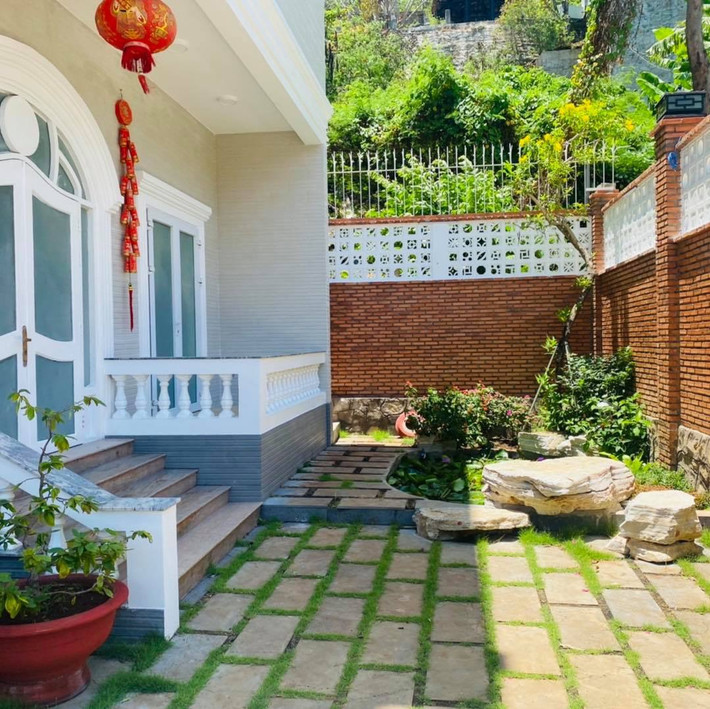 Khuôn viên sân vườn thiết kế đẹp mắt với nhiều cây xanh, tiểu cảnh.
