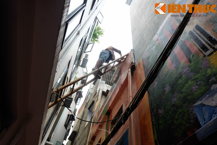 Hơn nữa, con ngõ hẹp nên các thợ vẽ phải trèo khá cao.