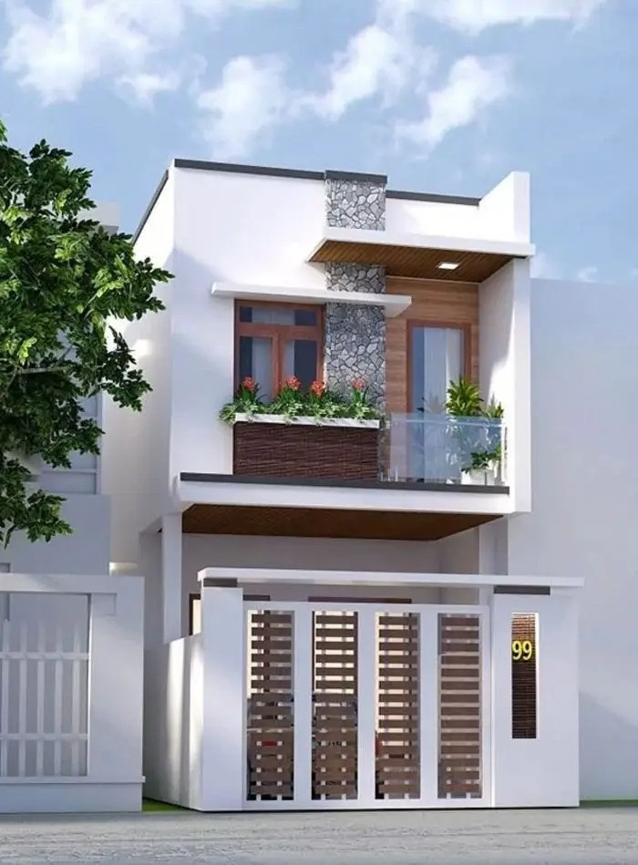 Nhà 2 tầng sử dụng tông màu sáng nổi bật kết hợp chất liệu ốp giả gỗ màu nâu đậm tạo sự tương phản làm tăng tính thẩm mỹ. Ảnh: Namidesign