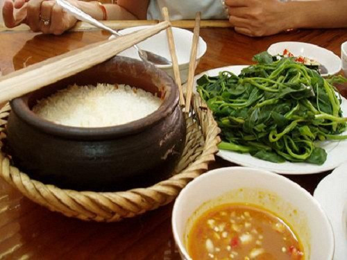 Đôi đũa cả dùng để đảo cơm khi sôi, và xới cơm nữa. Ảnh: Chuaphuclam.