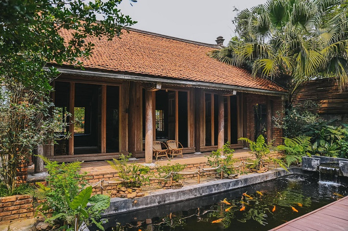 Công trình gồm 2 hạng mục là nhà sàn và nhà 3 gian. Phía trước nhà 3 gian có bể cá Koi đẹp mắt. Ảnh: Thanh Nhan Dang.