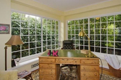 Phòng làm việc giản dị với tường kính hướng ra khu vườn yên tĩnh. Ảnh: Home.