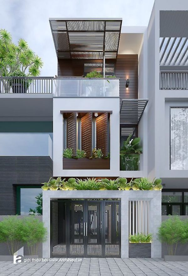 Nhà 3 tầng nổi bật với gàm màu trắng sáng và hệ lam chắn trên sân thượng. Ảnh: Kientrucsuvietnam.