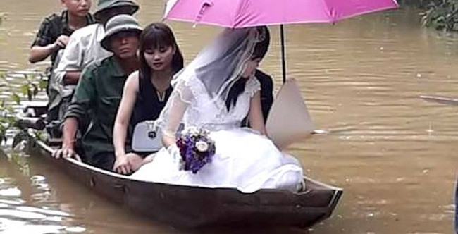 Không đi bộ, đi xe được vì nước ngập vào tháng 10 vừa qua, cặp đôi ở huyện Hương Khê, tỉnh Hà Tĩnh đã đi thuyền trong ngày cưới.