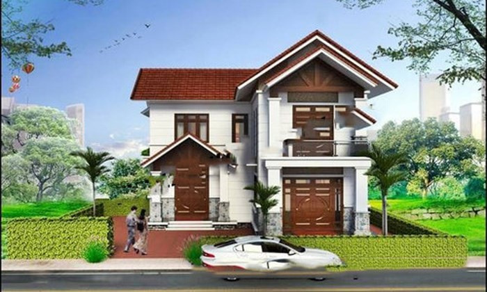 Nhà 2 tầng hình chữ L tinh tế nhờ lớp sơn màu trắng chủ đạo kết hợp hài hòa với hệ thống cửa gỗ. Ảnh: Nhadepktv.