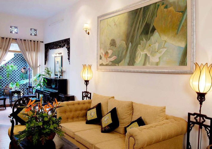 Nội thất ngôi nhà của Thúy Nga ấm áp với tông màu chủ đạo là màu vàng. Bức tranh sen trắng và những chiếc đèn trang trí hình hoa sen cùng với màu sắc của nội thất mang đến cho căn phòng hơi hướng của thiền và sự bình yên kỳ lạ.