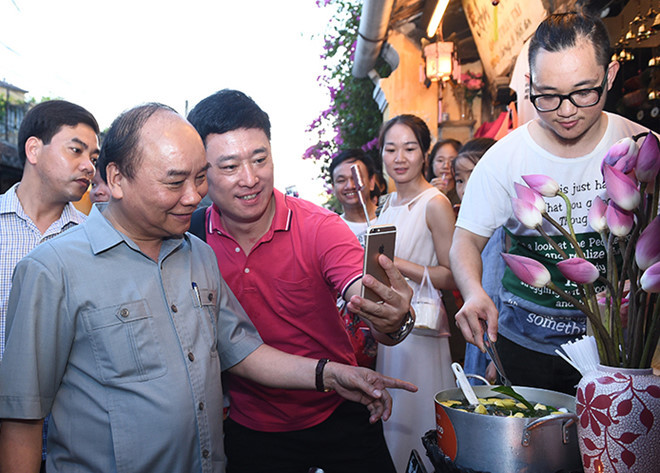 Nhiều người dân đã mạnh dạn tới chụp ảnh kỷ niệm với Thủ tướng. Nguồn ảnh: Tổ quốc.