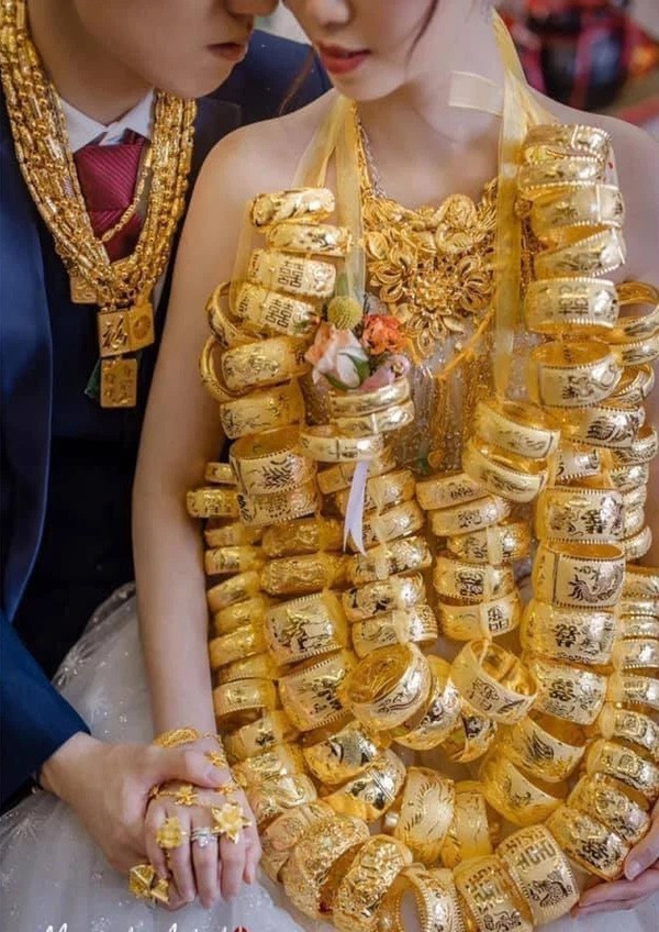 Ngoài cô dâu thì chú rể cũng được tặng dây chuyền, vòng tay và rất nhiều nhẫn vàng khiến mọi người ghen tị.