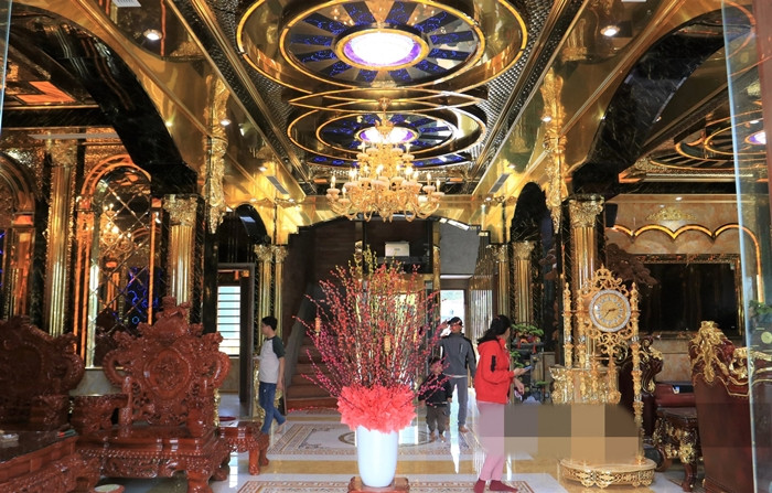 Tầng 1 là phòng khách với không gian rộng lớn cùng nội thất gỗ chạm khắc tinh xảo. Ảnh: Dân việt