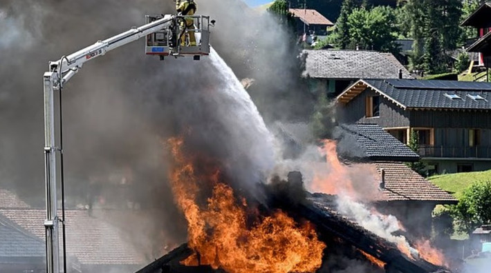 Lính cứu hỏa dập tắt đám cháy tại một ngôi nhà gỗ ở trung tâm khu nghỉ dưỡng Morgins, phía tây Thụy Sĩ, trong đợt nắng nóng. Ảnh: Getty.