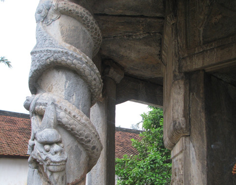 Tượng rồng chầu trên cột trước cửa tháp.