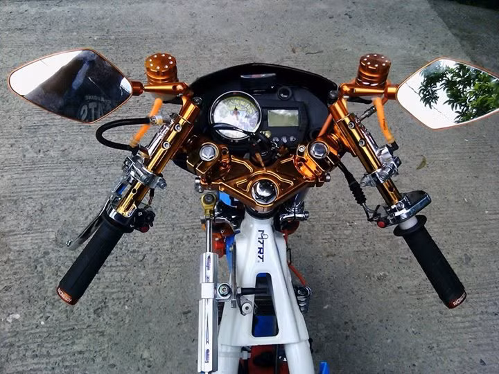 Dàn ghi đông CNC mạ màu chói lóa, bình dầu và kính hậu hiệu Racing Boy cùng cây trợ lực sườn chắc chắn.