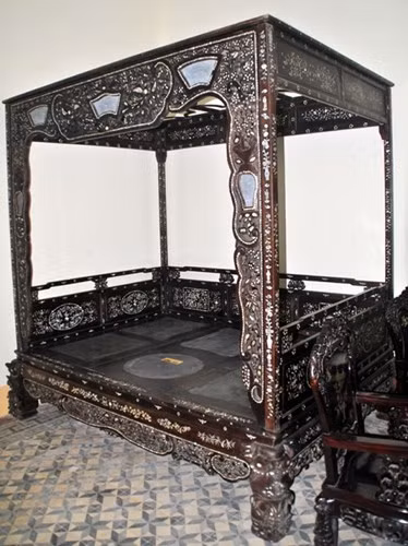 Chiếc giường được đóng bằng gỗ sưa (huỳnh đàn) với nhiều hoa văn tinh xảo. Trên mỗi chiếc giường cổ này cẩn đến 30 kg ốc xà cừ (giá thị trường hiện khoảng 200 triệu đồng/kg).