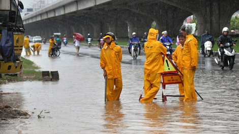 Công nhân thoát nước phải ứng trực trên đường Phạm Hùng để xử lý úng ngập.