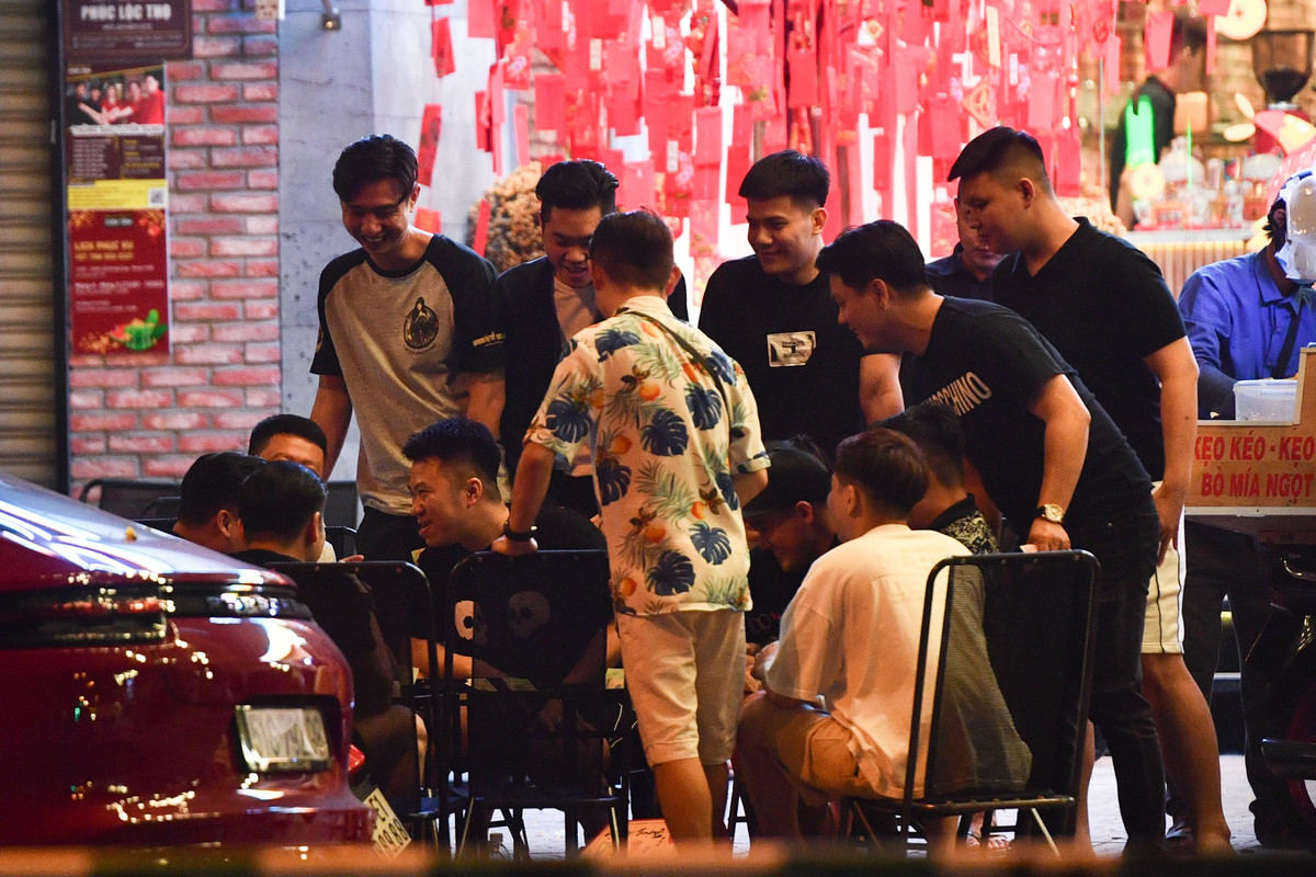 Ngoài quán nhậu, nhiều quán cà phê cũng rất đông khách. Một nhóm khách tụ tập, nói chuyện trên vỉa hè ở một quán cà phê trên đường Quách Thị Trang (quận 1) lúc 0h.