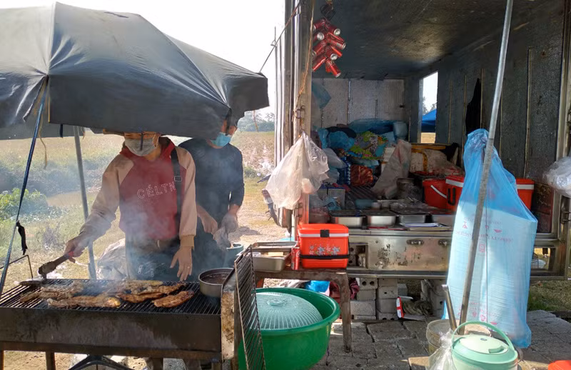 Mo quan com di dong tren xe tai, vo chong tre bam quoc lo kiem song-Hinh-2