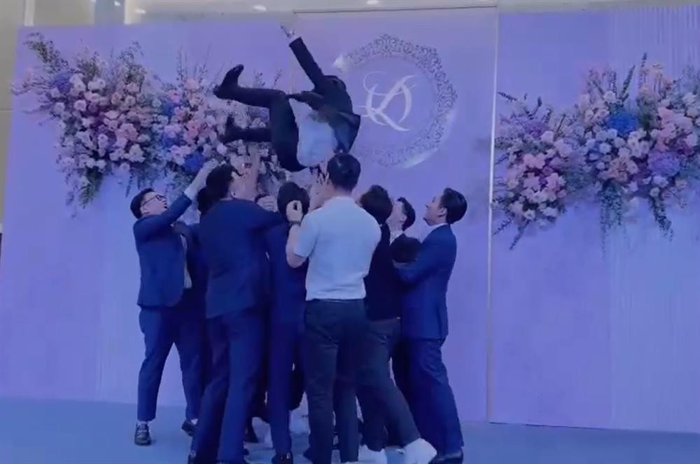Chú rể Đỗ Vinh Quang liên tục bị đám đông tung lên cao.