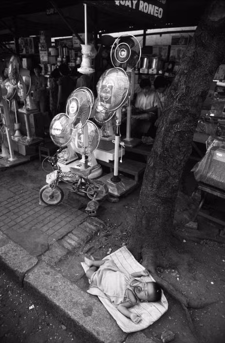 Giấc ngủ của em bé Sài Gòn năm 1988, một hình ảnh độc về vỉa hè Việt Nam. Ảnh: Philip Jones Griffiths.